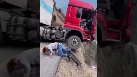 Truck driver jumps out seconds before landslide sends rig into ravine