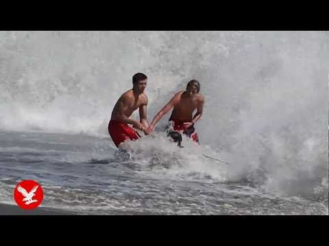 Dramatic rescue sees teen lifeguard battle terrifying waves to save boy dragged out to sea