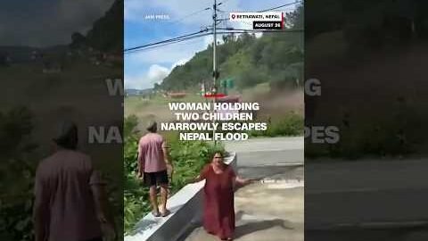 Woman holding two children narrowly escapes Nepal flood
